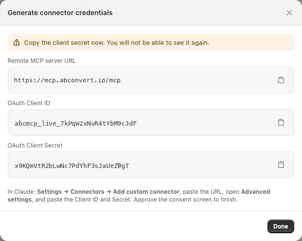 The Generate connector credentials modal showing the remote MCP server URL, an OAuth client ID, and an OAuth client secret, each with a copy button.