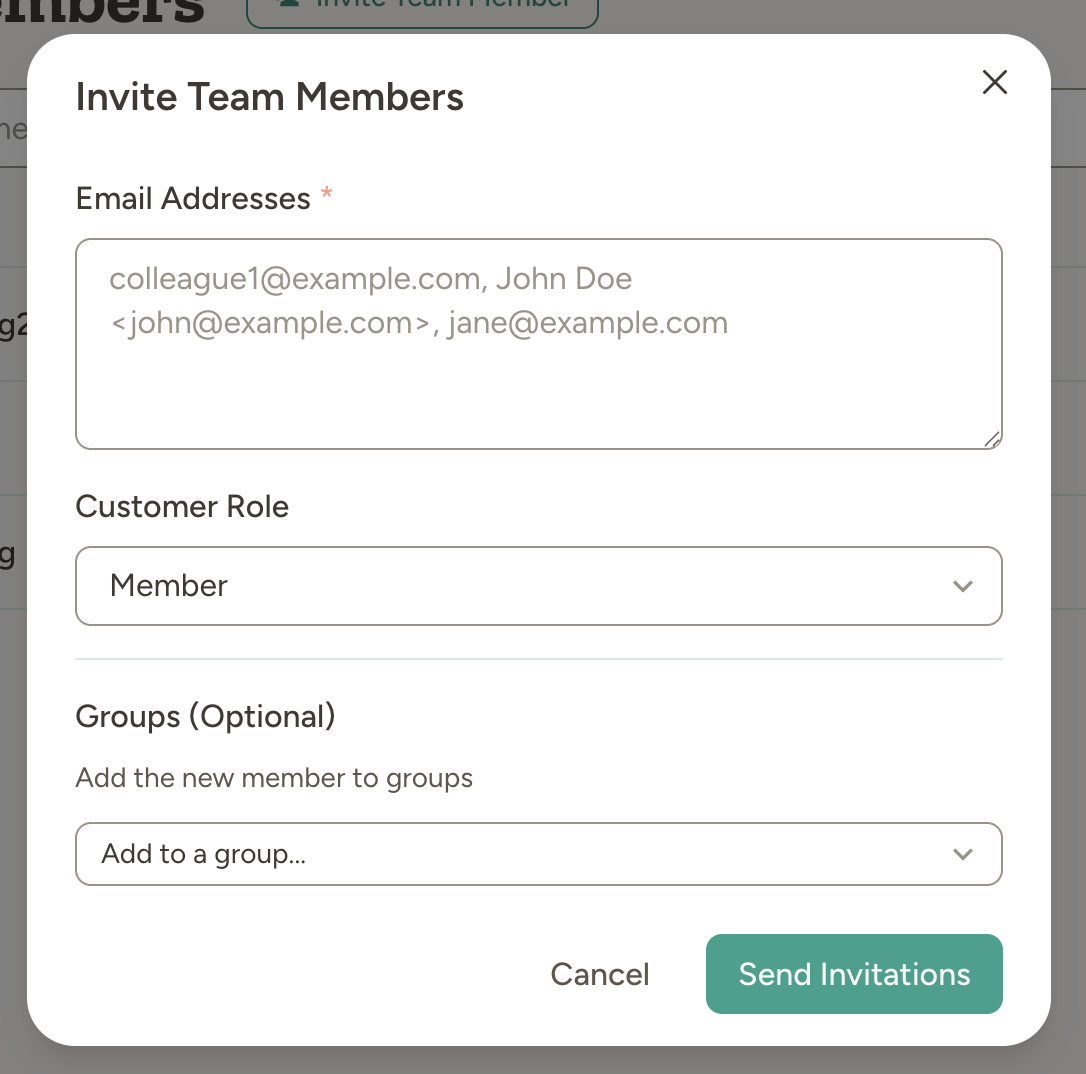 Invite Team Members modal showing email input, role selection, and optional group assignment