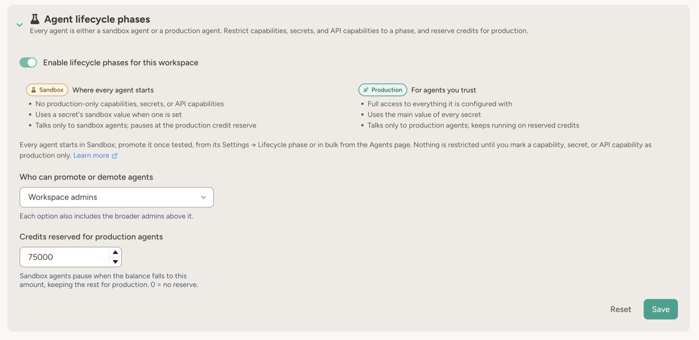 Workspace settings card for agent lifecycle phases: the enable toggle, the Sandbox and Production phases side by side with what each means, and the settings for who can promote agents and how many credits are reserved for production