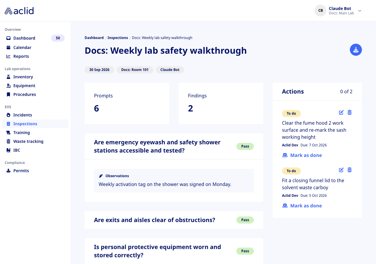 Completed inspection with Pass badges and two open actions