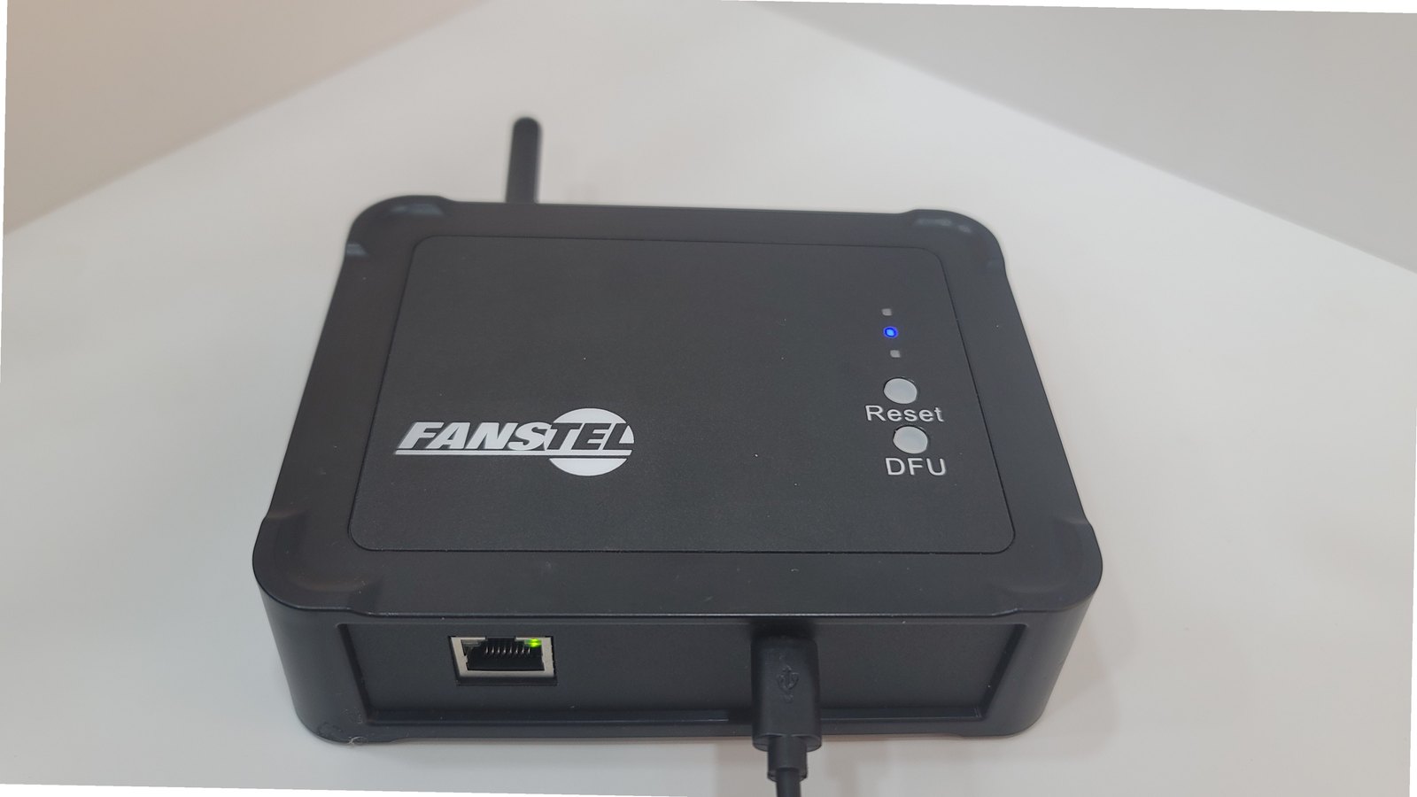 The Fanstel LEW840X from the front, showing the Ethernet port with its link LED lit and the micro-USB power connector