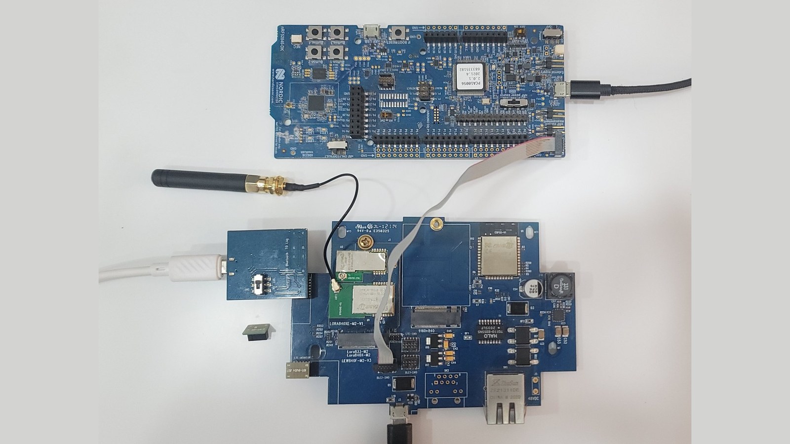 The gateway wired for programming, with the nRF52 DK and the UART bridge both connected
