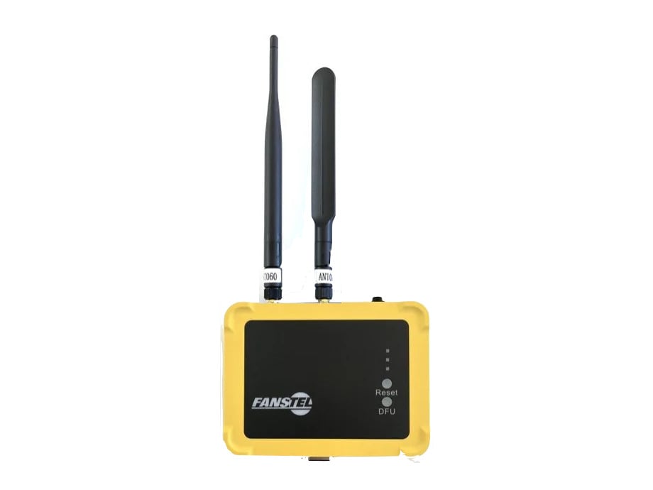 The yellow outdoor-rated Fanstel LEW840x, closed, with the 2.4 GHz antenna and the wider cellular antenna fitted