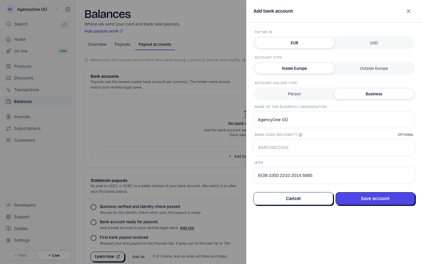 The Add bank account panel on the Payout accounts tab, with Pay me in set to EUR, Account type set to Inside Europe, Account holder type set to Business, the business name AgencyOne OÜ, an empty optional bank code and an Estonian IBAN