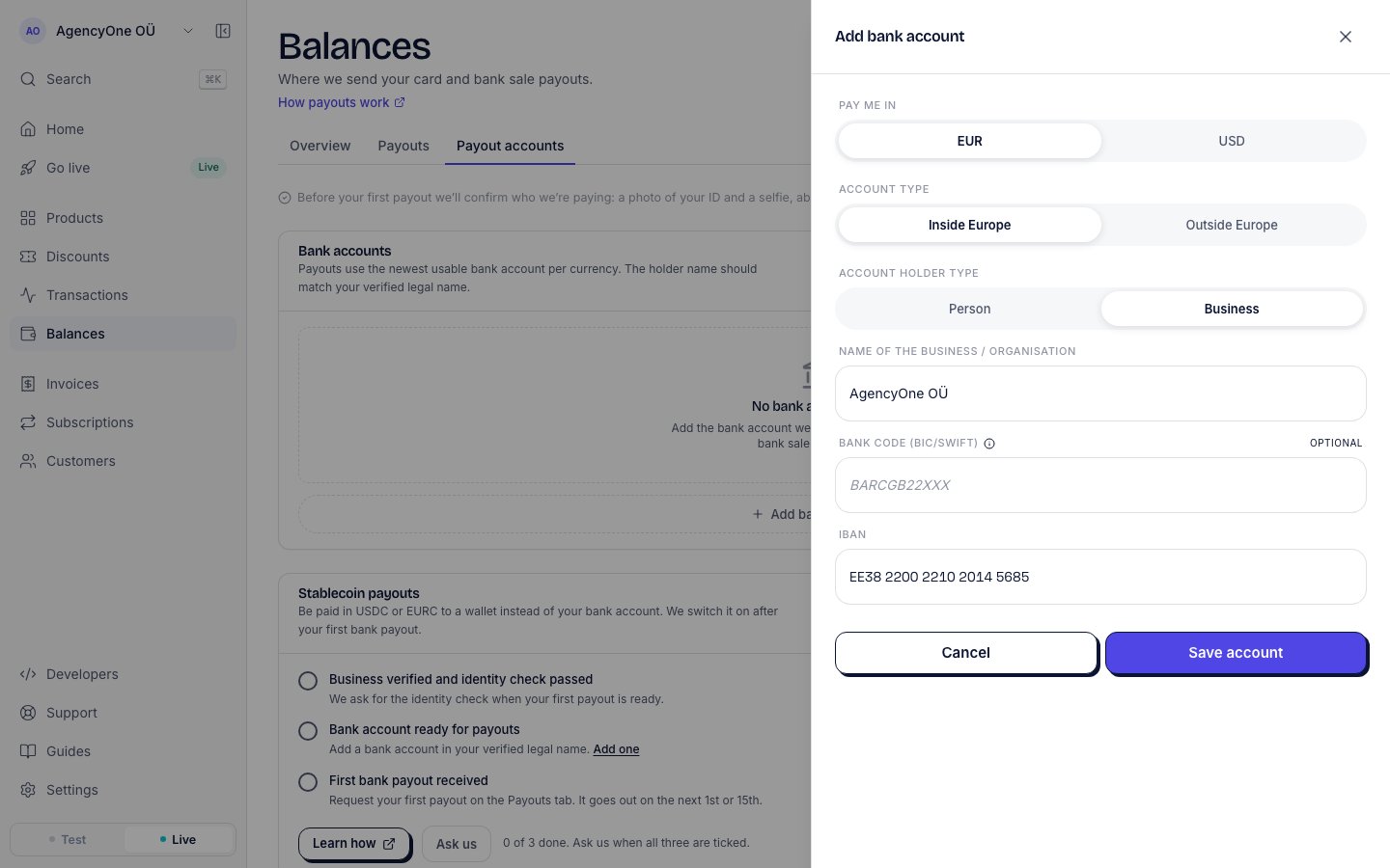 The Add bank account panel on the Payout accounts tab, with Pay me in set to EUR, Account type set to Inside Europe, Account holder type set to Business, the business name AgencyOne OÜ, an empty optional bank code and an Estonian IBAN