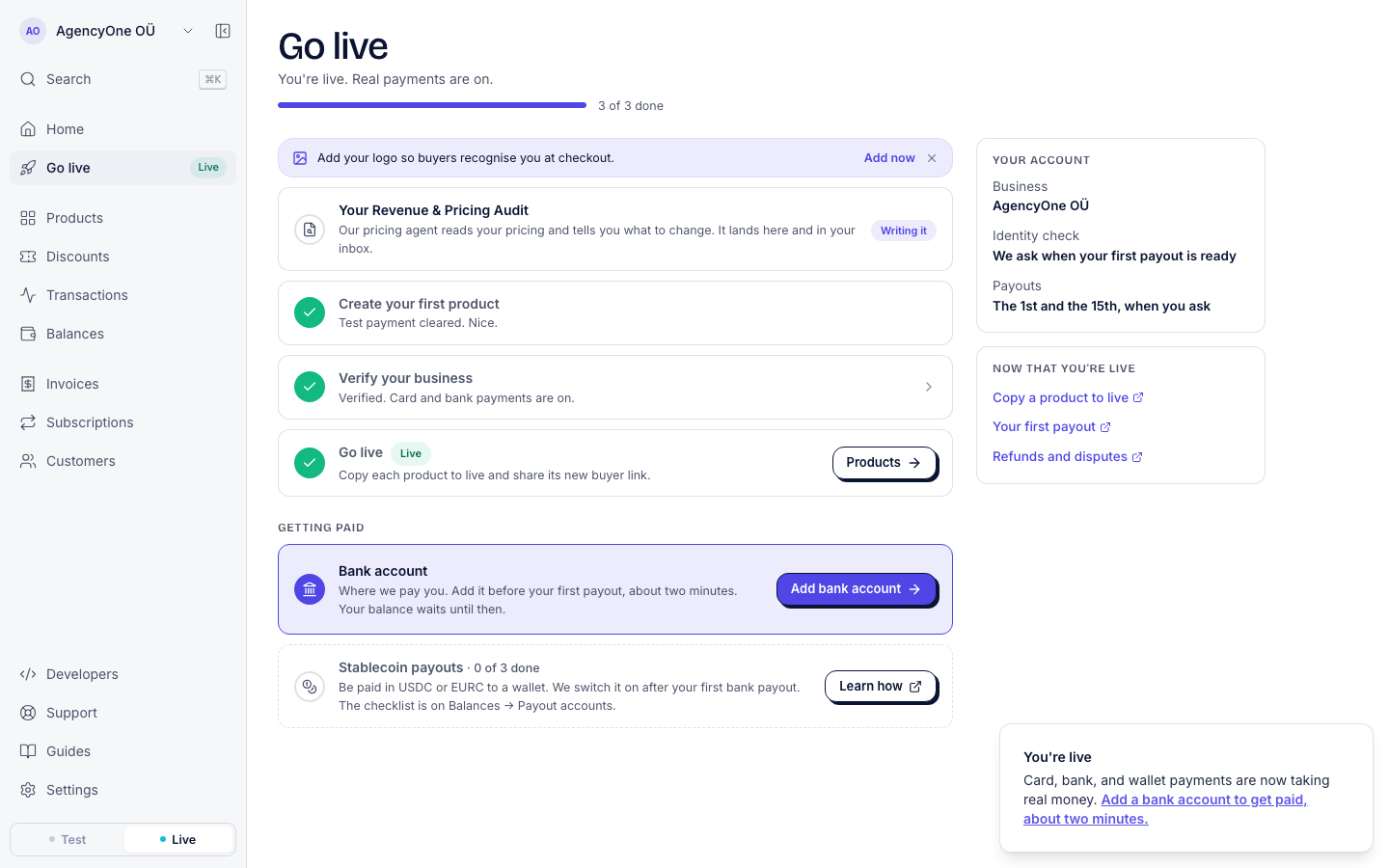 Go live page in live mode showing 3 of 3 done. Under Getting paid, the Bank account row is highlighted and says: Where we pay you. Add it before your first payout, about two minutes. Your balance waits until then. It has the button Add bank account. The Stablecoin payouts row below it says 0 of 3 done. At the bottom right, the message You're live has the link Add a bank account to get paid, about two minutes.