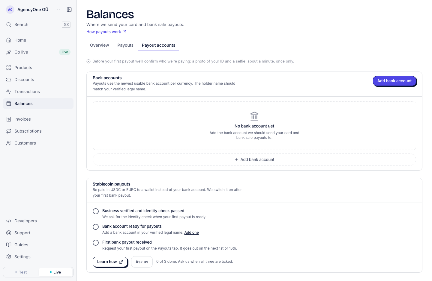 The Balances page, Payout accounts tab, in live mode. Above the payout accounts, a note says: Before your first payout we’ll confirm who we’re paying: a photo of your ID and a selfie, about a minute, once only.