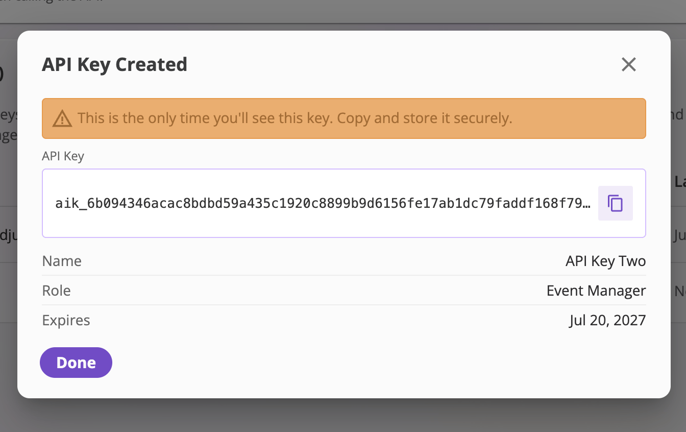 The API Key Created dialog showing a warning that this is the only time the key will be shown, the key value in a monospace box with a copy button, a summary of the key's name, role, and expiration, and a Done button.