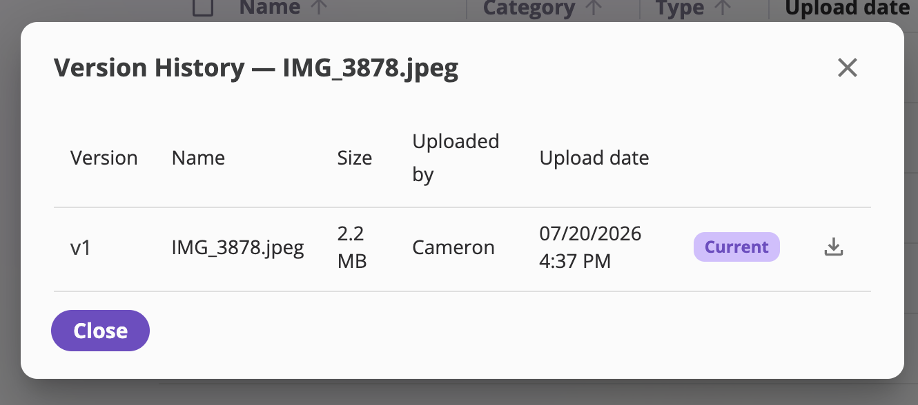 The Version History dialog for a file, listing versions v3, v2, v1 with Name, Size, Uploaded by, and Upload date columns, a Current badge on the newest version, and per-version download and restore icons.