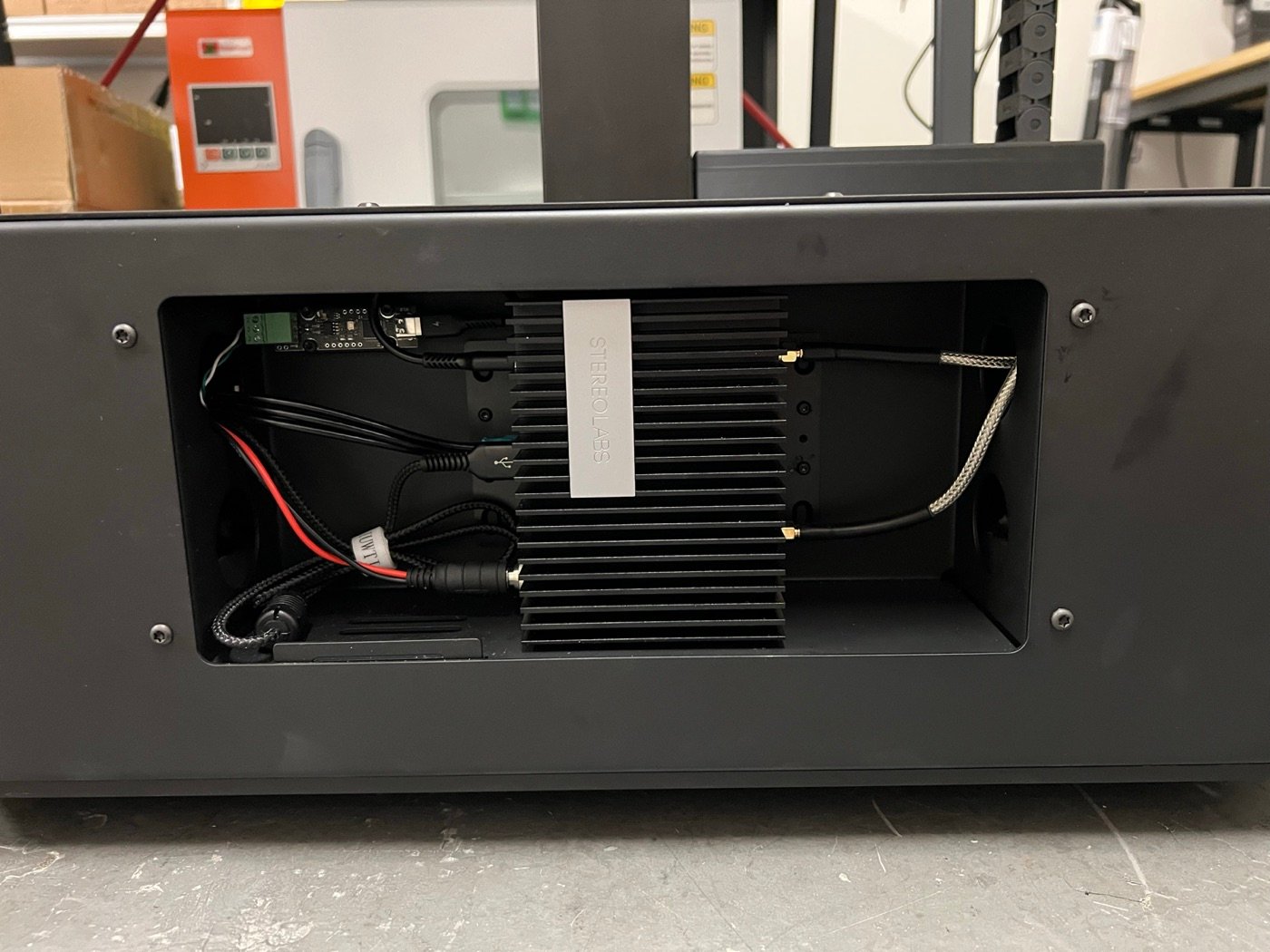 The compute mounted inside Jelly's base compartment, with the power, USB, and antenna cables connected