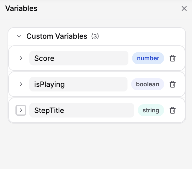 Variables pane showing Score, isPlaying, and StepTitle custom variables with type badges and delete icons