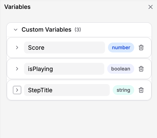 Variables pane showing Score, isPlaying, and StepTitle custom variables with type badges and delete icons
