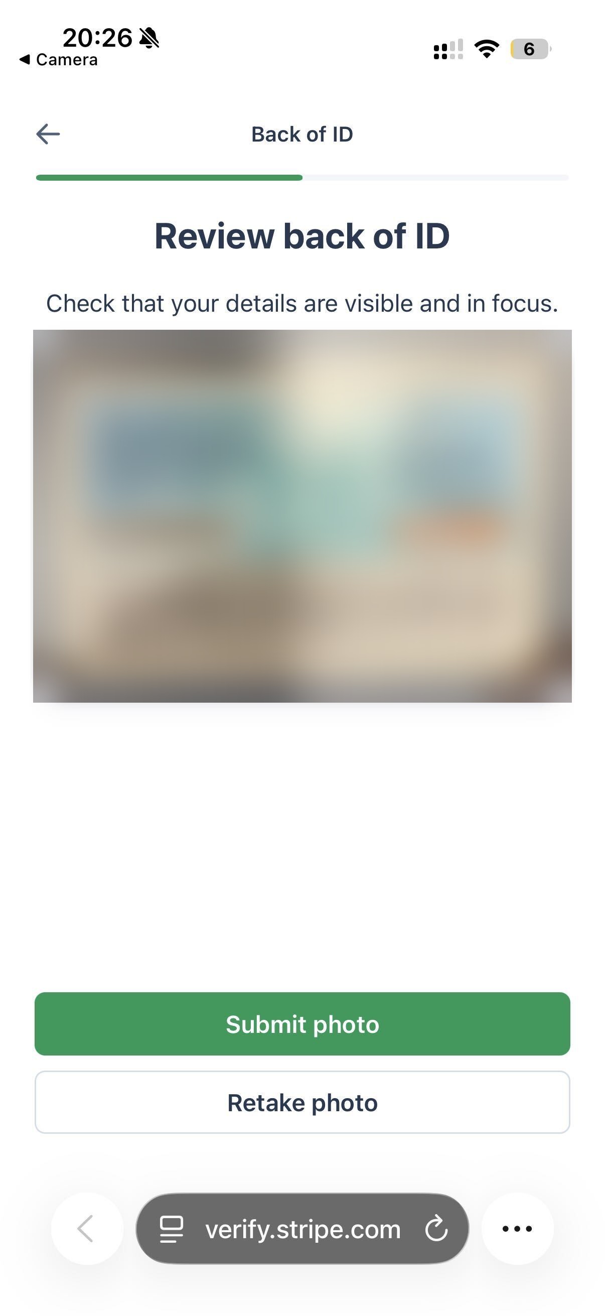 Phone screen showing the captured back of an ID for review, with Submit photo and Retake photo buttons