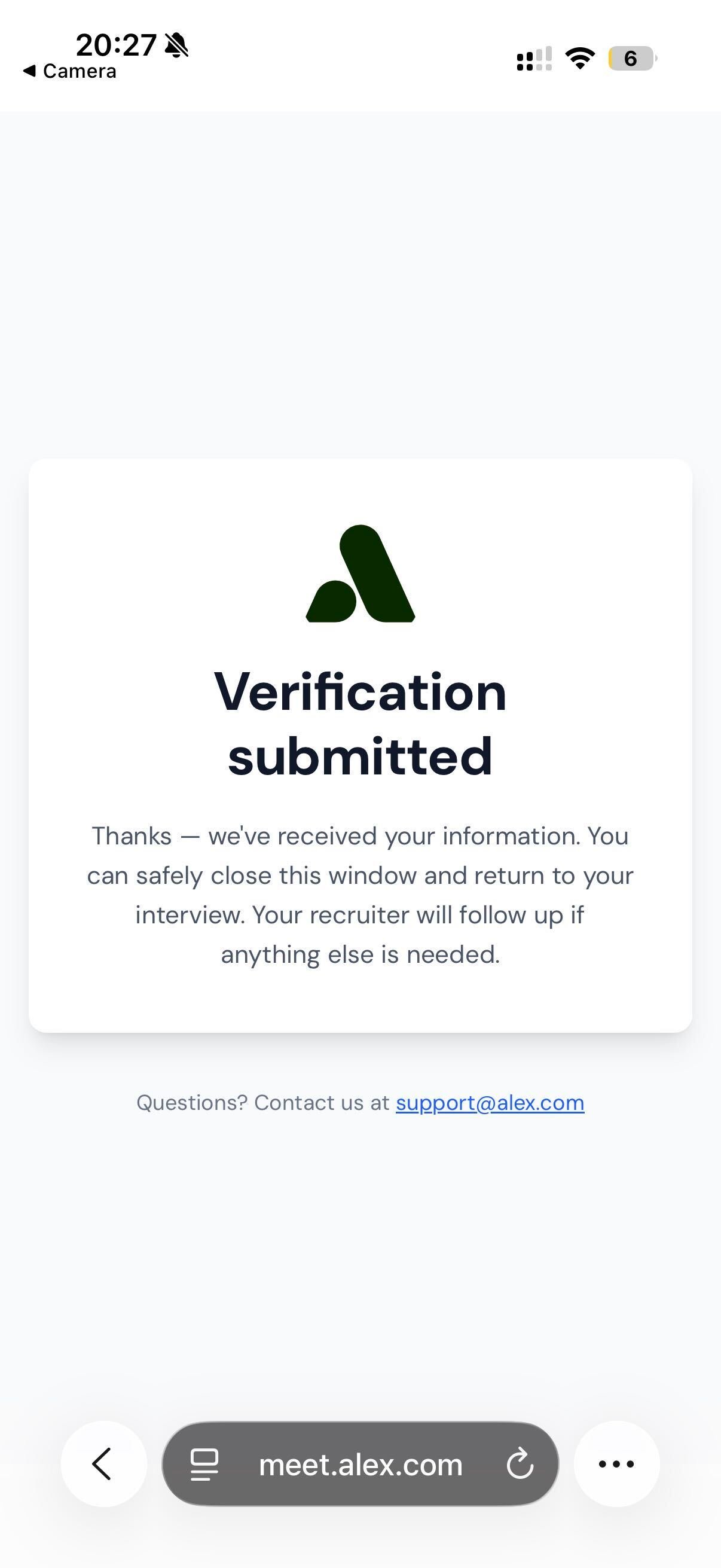Phone screen confirming the verification was submitted and the candidate can return to their interview