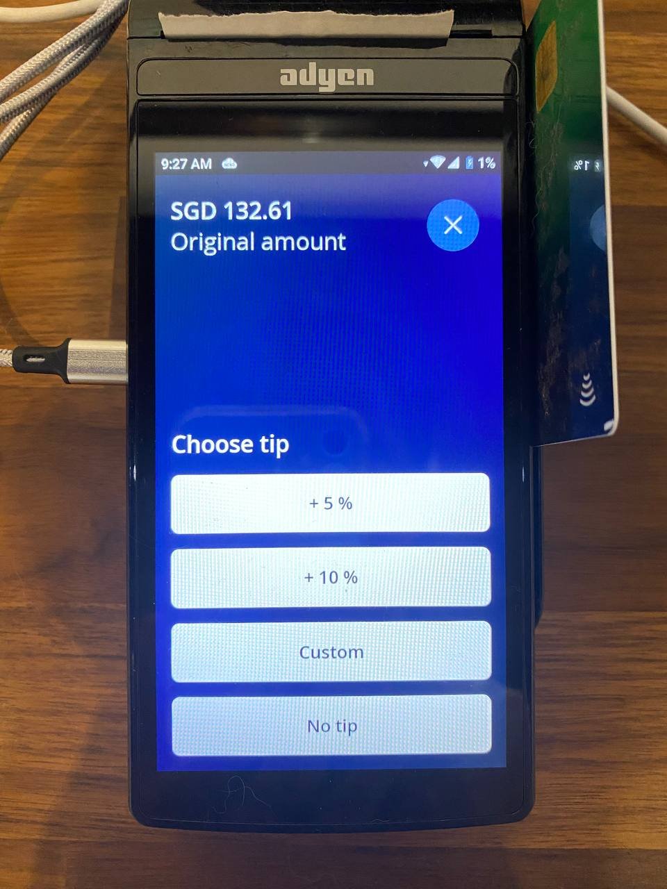 Card terminal showing the original amount of SGD 132.61 and a Choose tip prompt with +5%, +10%, Custom, and No tip options.