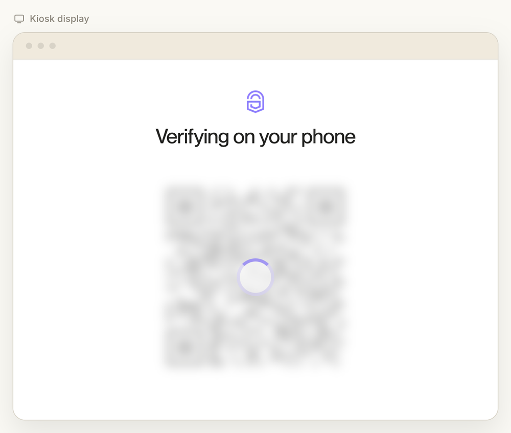 A kiosk screen with the heading Verifying on your phone above an obscured QR code and a spinner