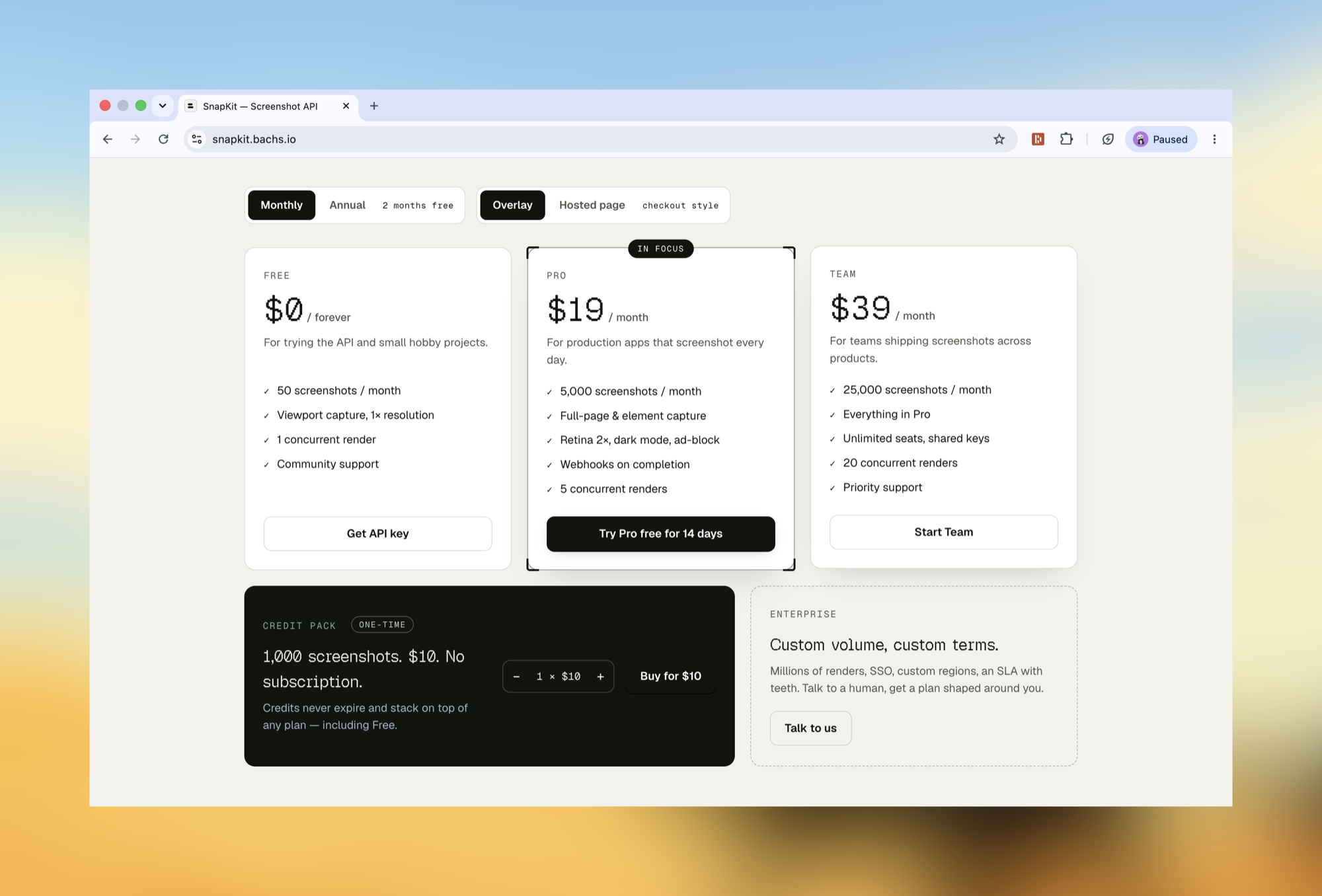 The pricing section with the Monthly/Annual and Overlay/Hosted page toggles, three plans, and the one-time credit pack