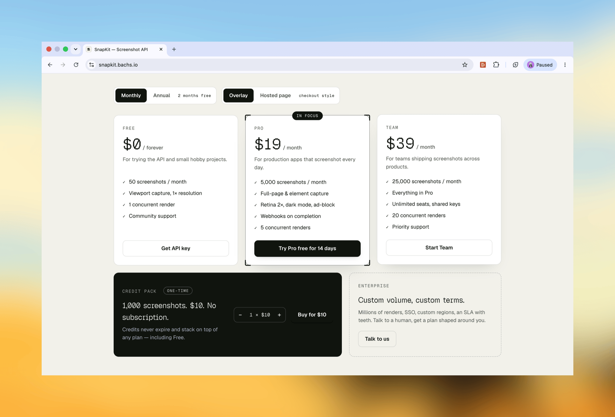 The pricing section with the Monthly/Annual and Overlay/Hosted page toggles, three plans, and the one-time credit pack