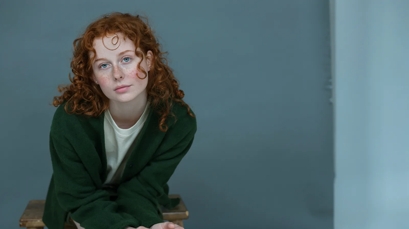 Portrait of a young woman with curly red hair