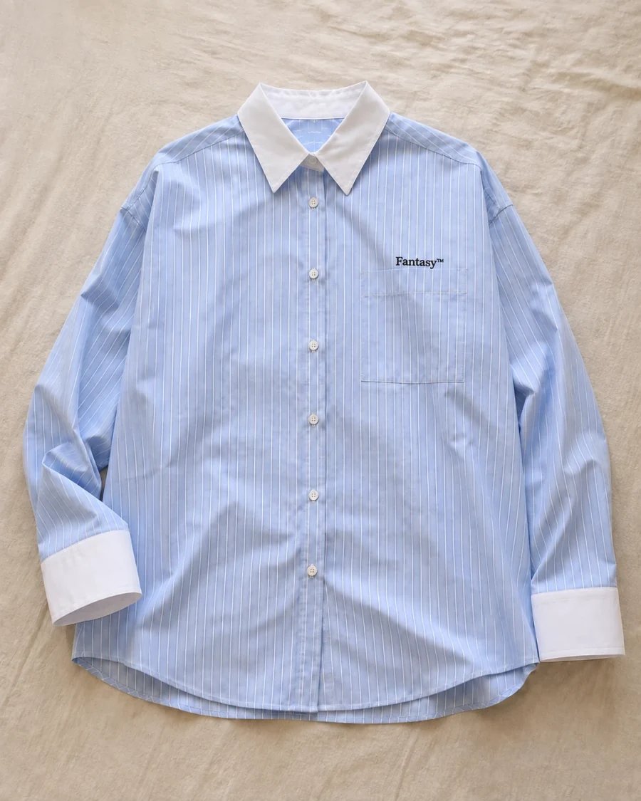 Flat-lay source photo of the blue striped shirt with both sleeves and white cuffs visible