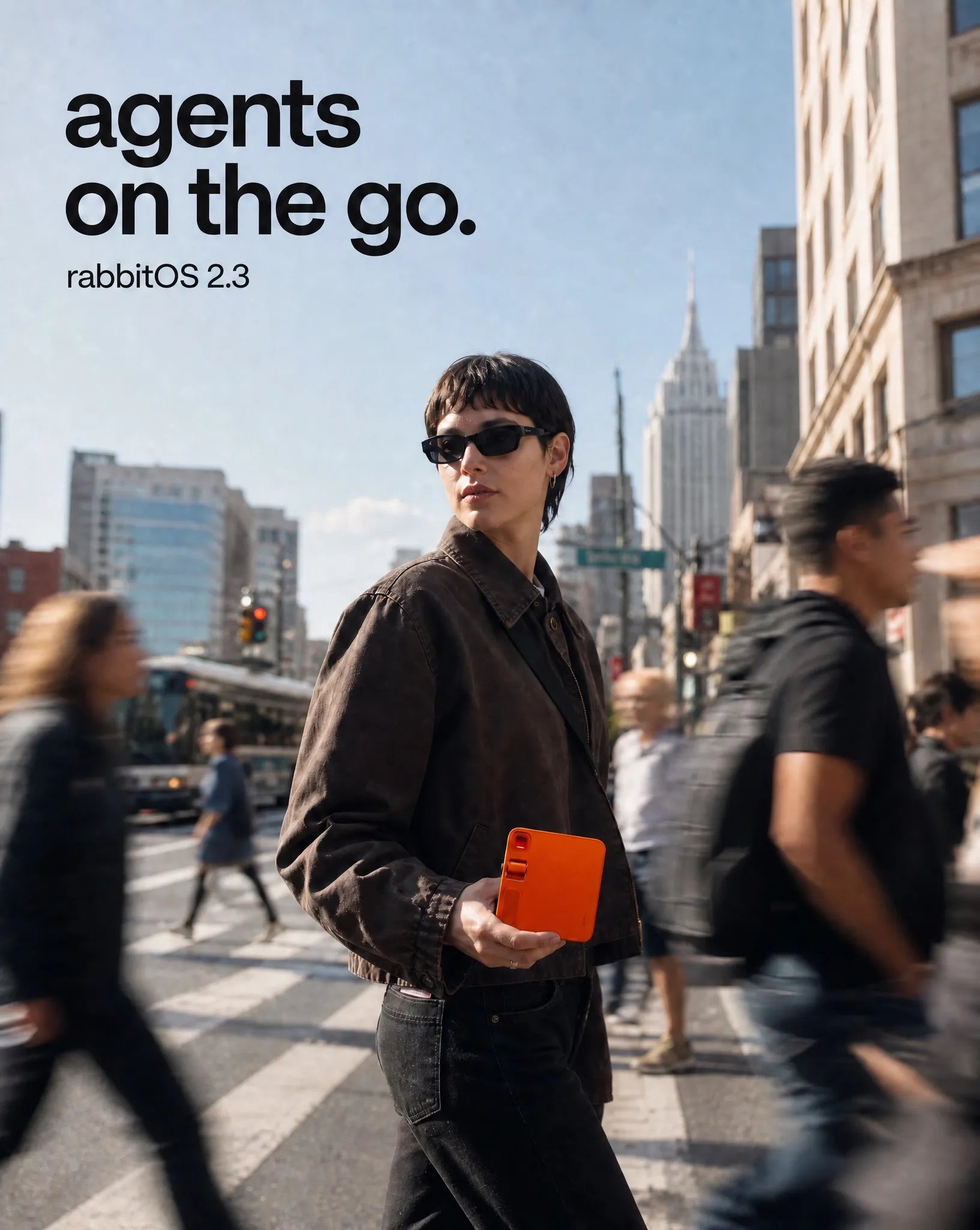 rabbit r1 campaign direction showing a person holding the orange device on a busy city street