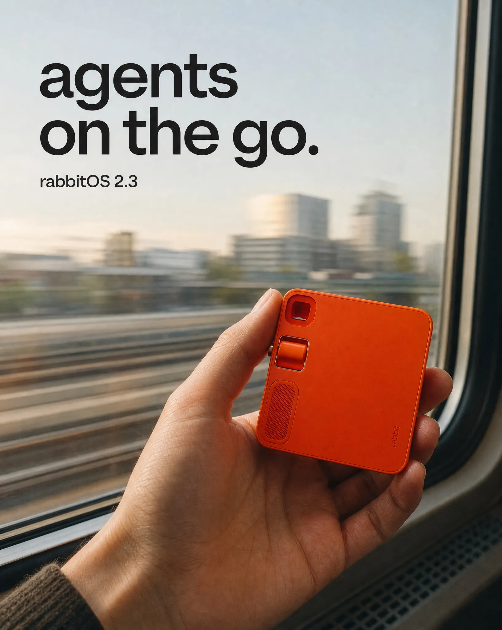 rabbit r1 campaign direction showing the orange device held beside a moving train window
