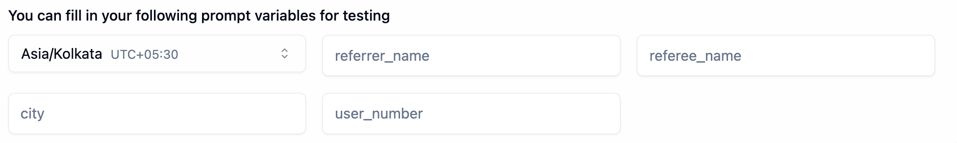 Prompt variables for testing section showing Asia Kolkata UTC plus 05 30 timezone selector and auto-detected variable fields for referrer_name, referee_name, city, and user_number