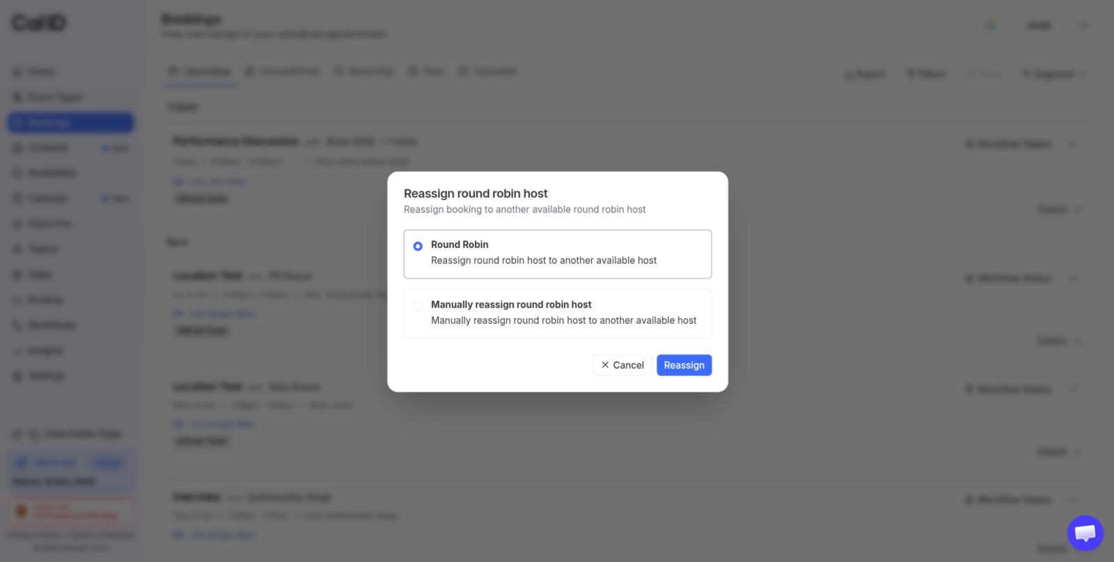 Reassign round robin host dialog with two selectable options, Round Robin and Manually reassign round robin host, above a blue Reassign button