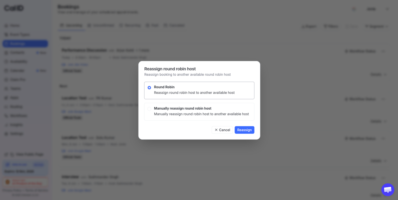 Reassign round robin host dialog with two selectable options, Round Robin and Manually reassign round robin host, above a blue Reassign button