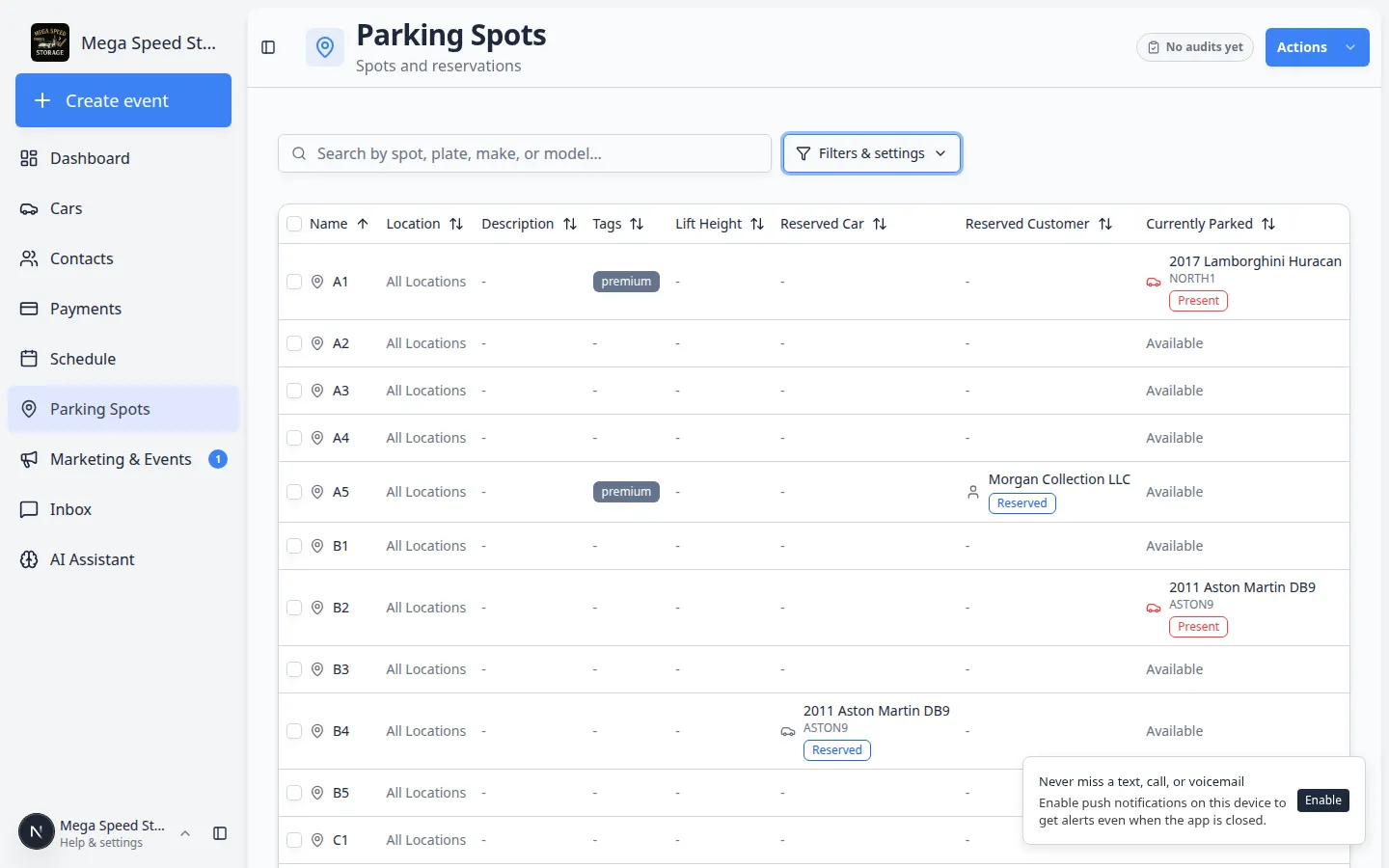 Parking Spots table view listing spot names, reserved customers, currently parked vehicles, and status