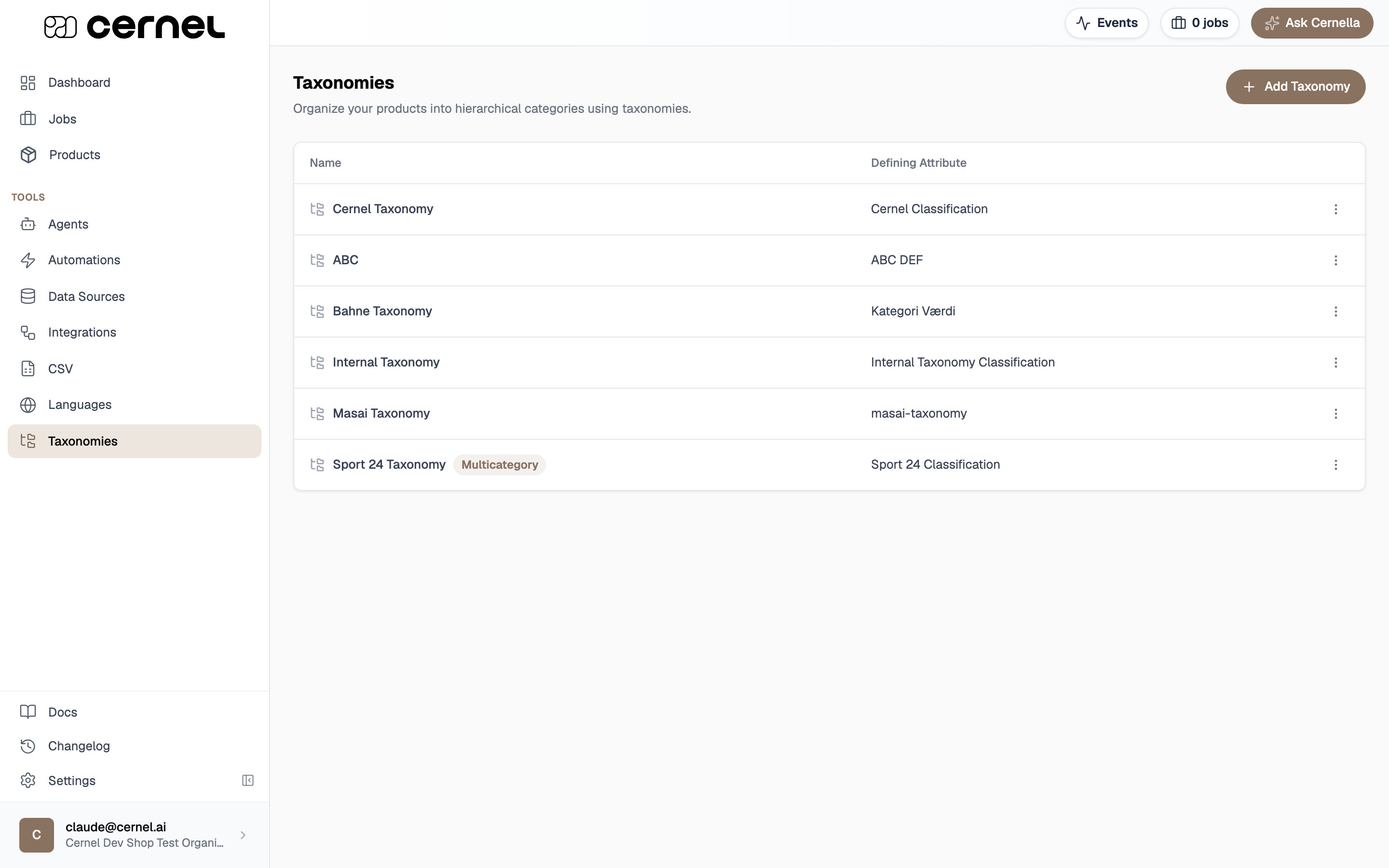 The Taxonomies page listing several taxonomies in a table with Name and Defining Attribute columns, a per-row actions menu, and an Add Taxonomy button in the top right
