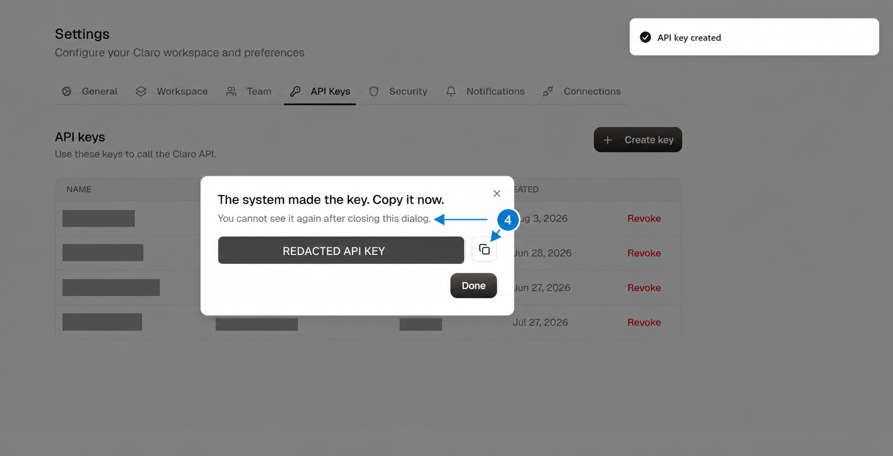 One-time API key dialog with the key redacted and arrows highlighting the warning and copy button