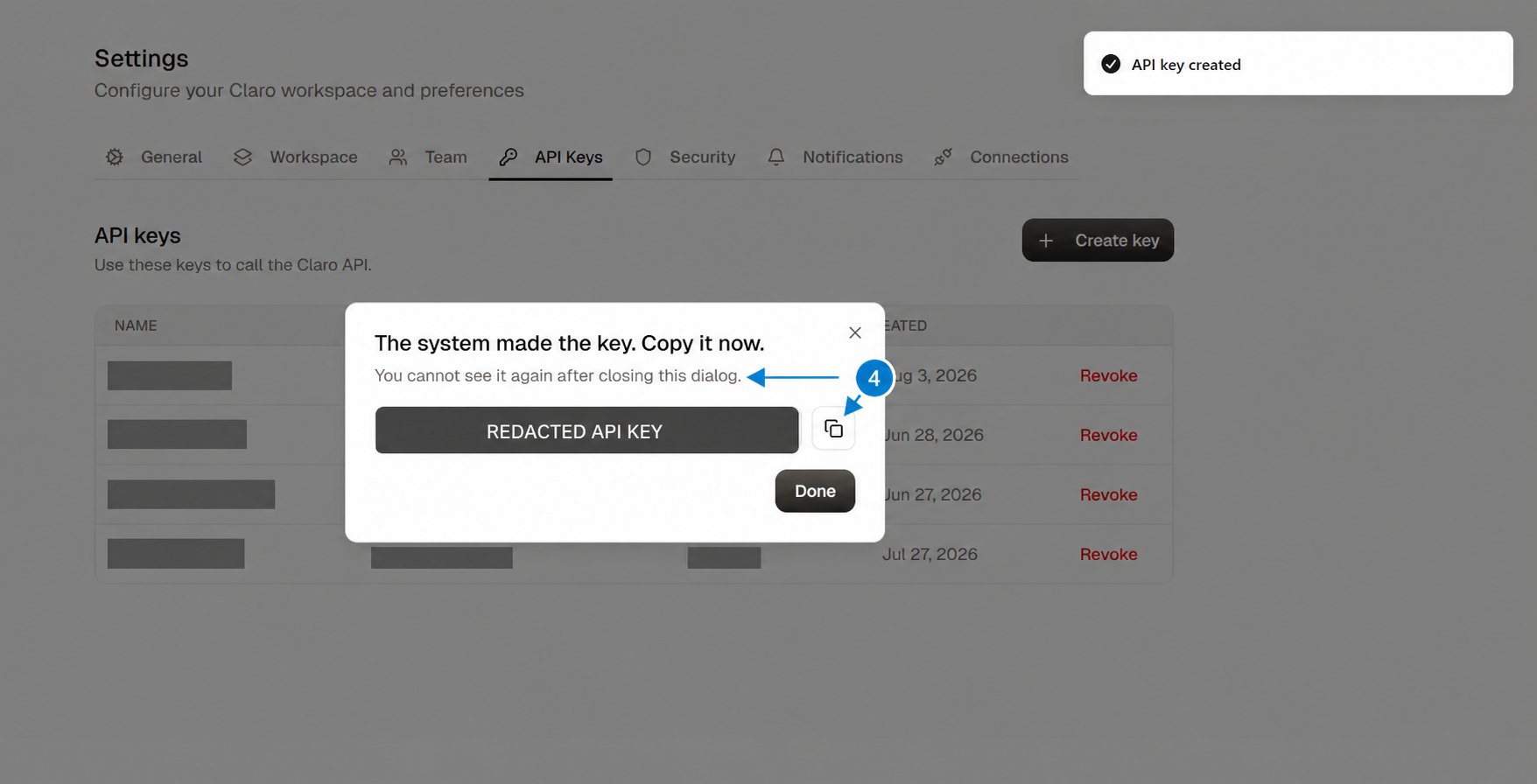 One-time API key dialog with the key redacted and arrows highlighting the warning and copy button