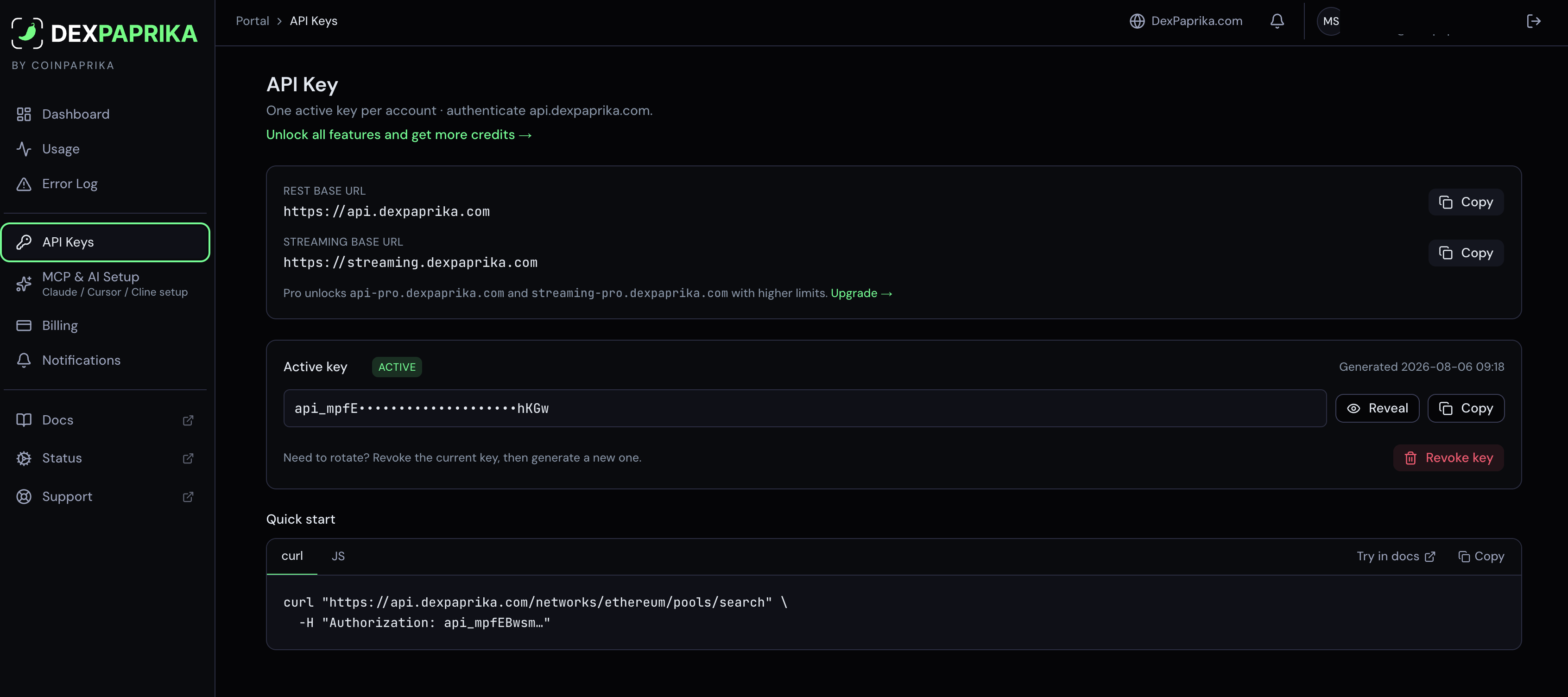 API Keys screen showing the REST and streaming base URLs with copy buttons, the active key masked with reveal and copy controls, a revoke button, and a quick-start curl example using the Authorization header.