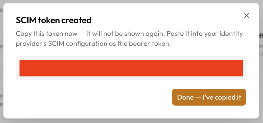 The SCIM token created dialog with the token hidden
