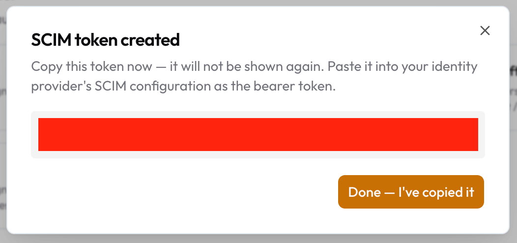 The SCIM token created dialog with the token hidden