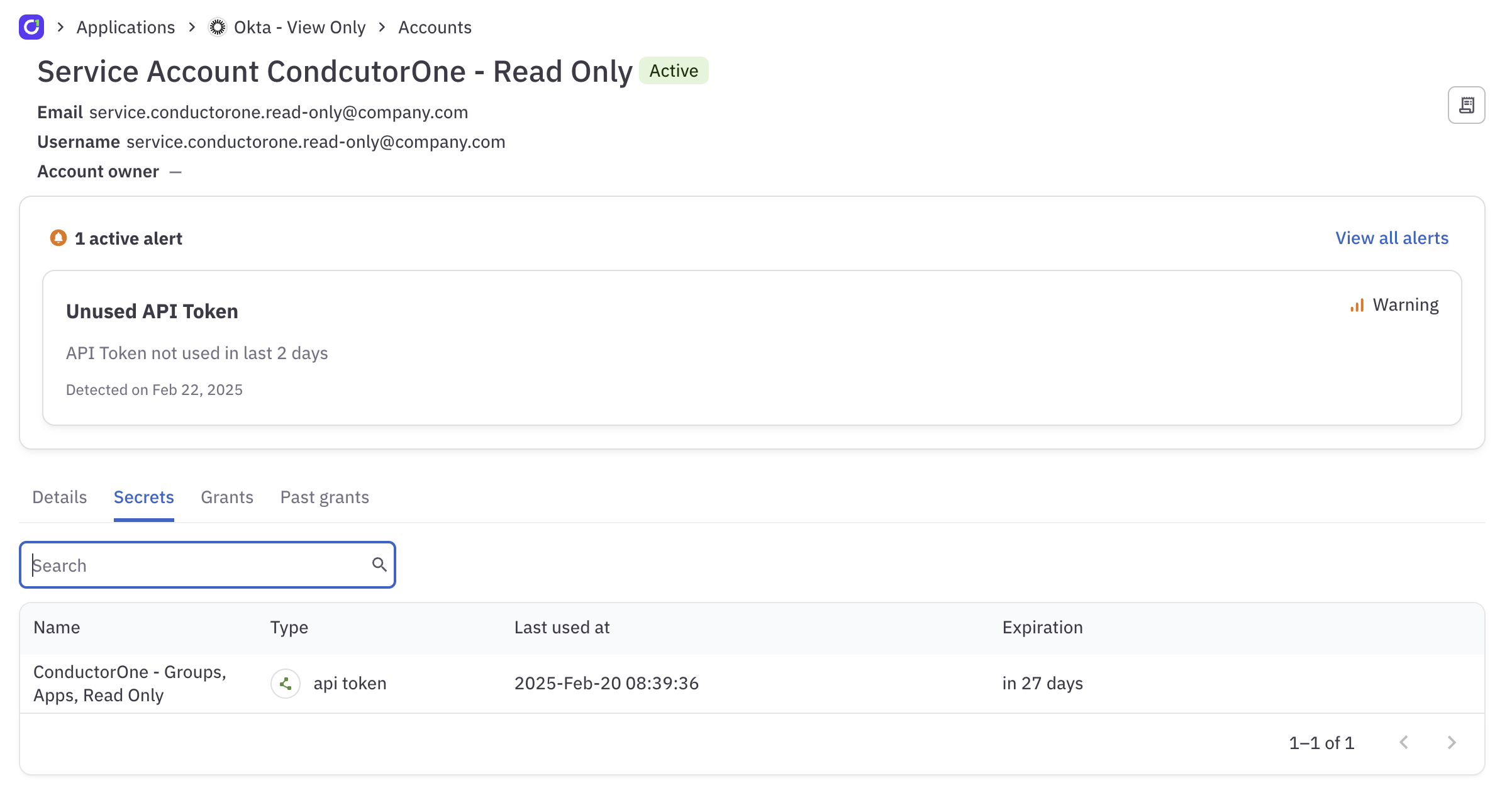 A screenshot of an identity's details page, showing one active alert for an API token that has not been used in two days.