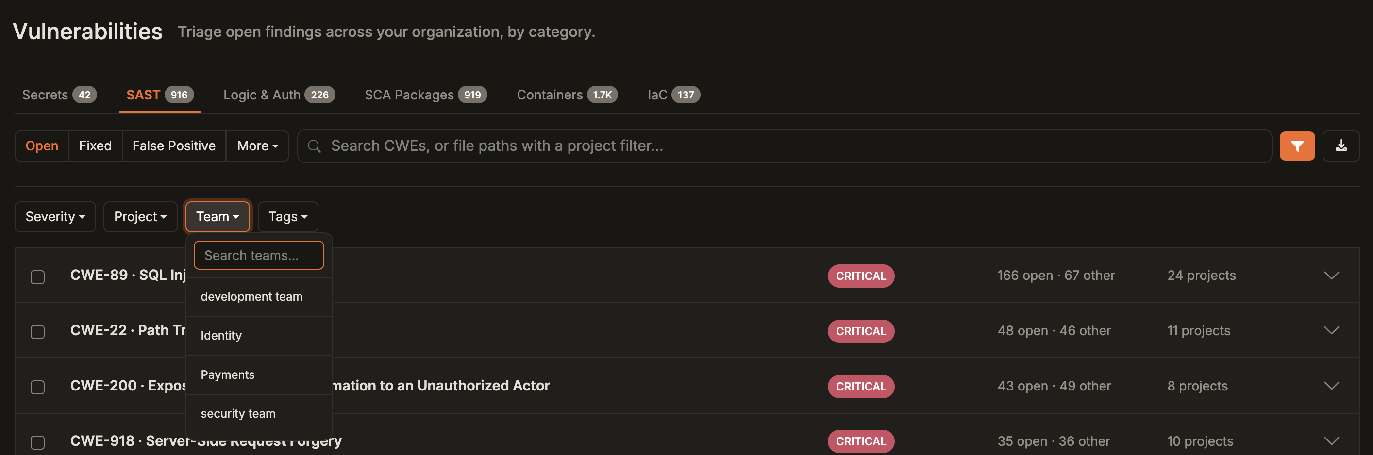 Vulnerabilities Workbench with the filter row open and the Team menu showing a team search