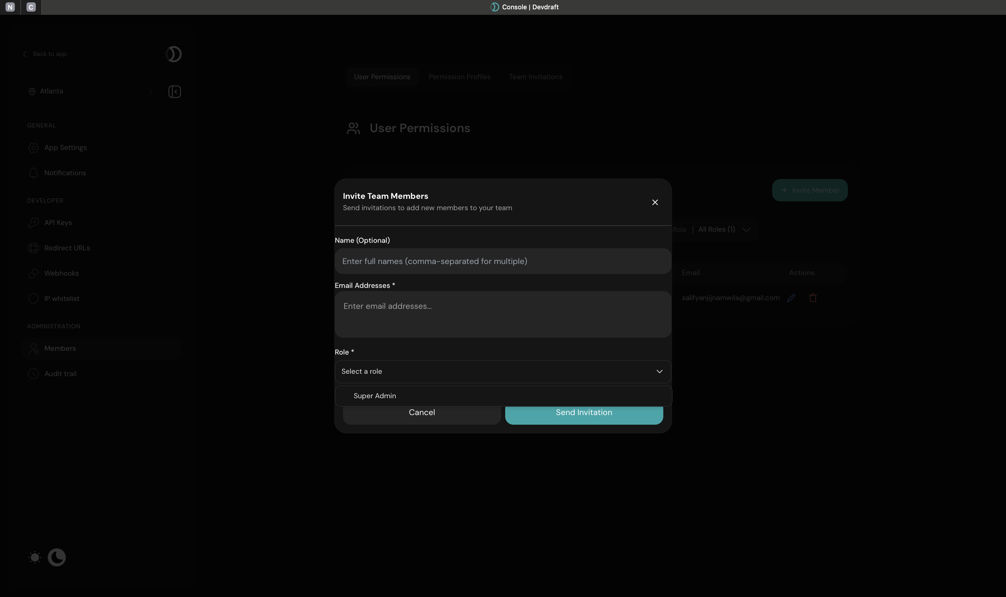 Invite team member interface with email and role selection - dark mode