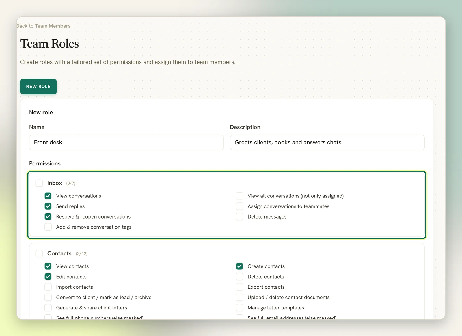 The New role form on Team Roles with the name Front desk and a description, and the Inbox permissions highlighted with three actions ticked