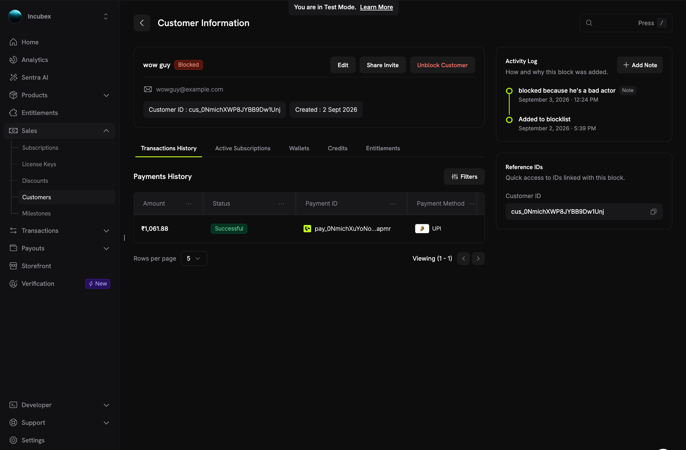 Customer Information page for a blocked customer showing the Blocked badge, an Unblock Customer button, an Activity Log with a note and the Added to blocklist event, and a Reference IDs panel with the customer ID