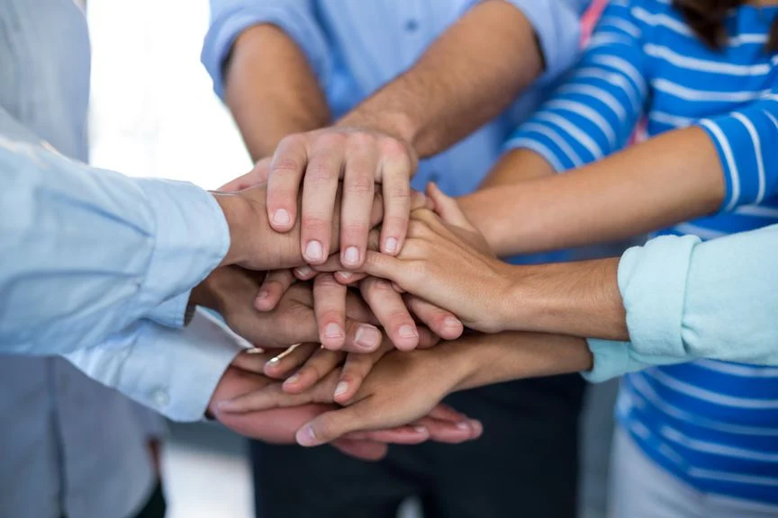 Team Businesspeople Forming Handstack