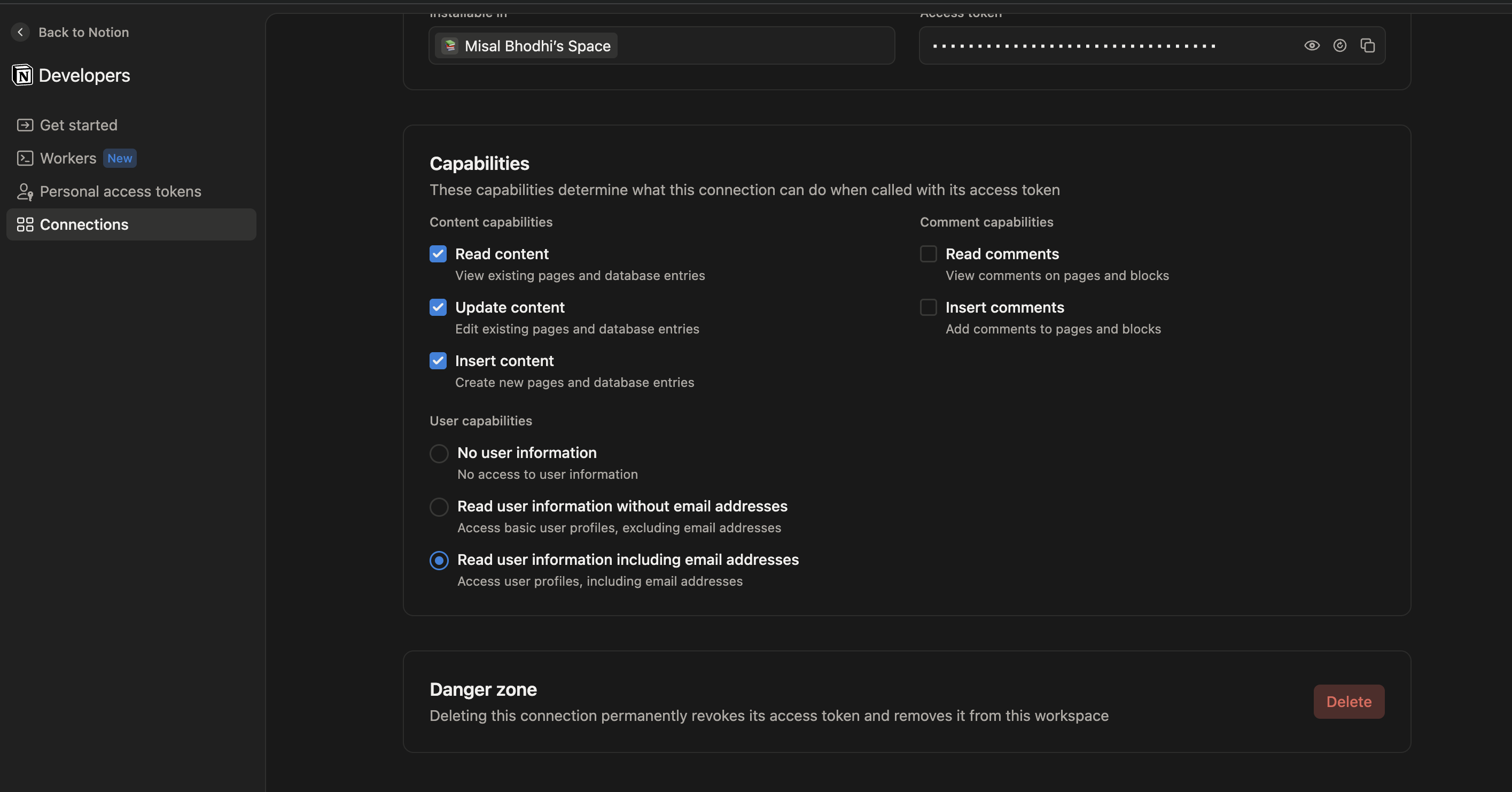 Notion connection settings showing the masked Access token field with a copy button and the Capabilities section with 'Read user information including email addresses' selected
