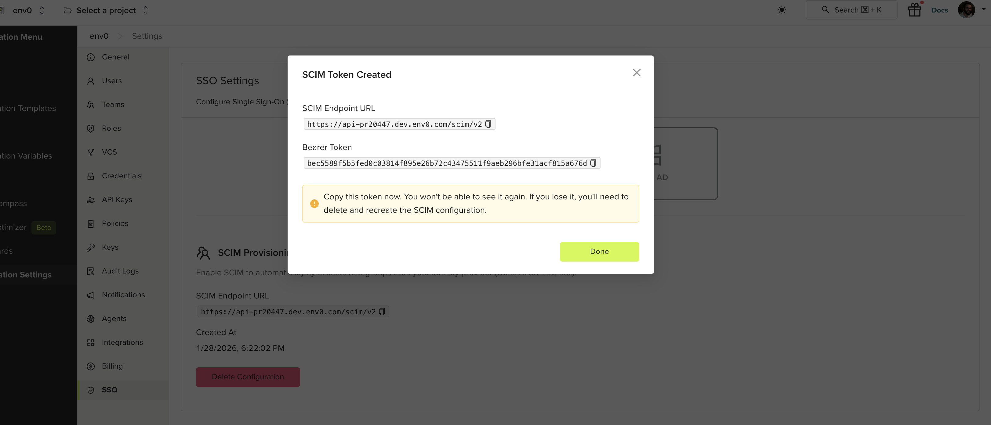 SCIM Token Created dialog showing the endpoint URL and bearer token