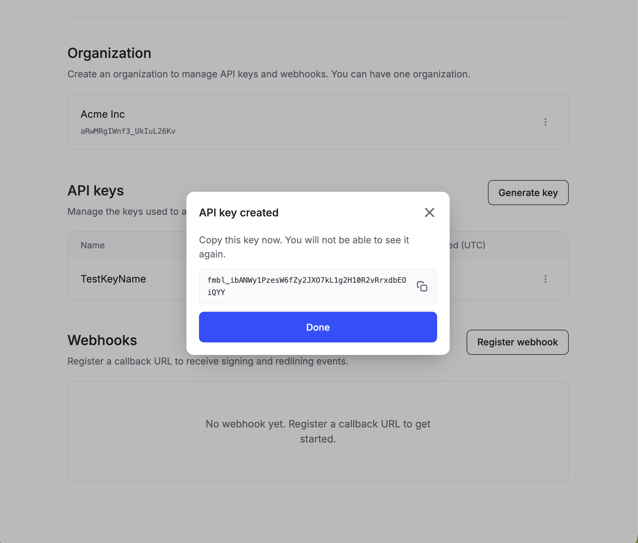 API key created modal showing a full fmbl_ key with a copy button