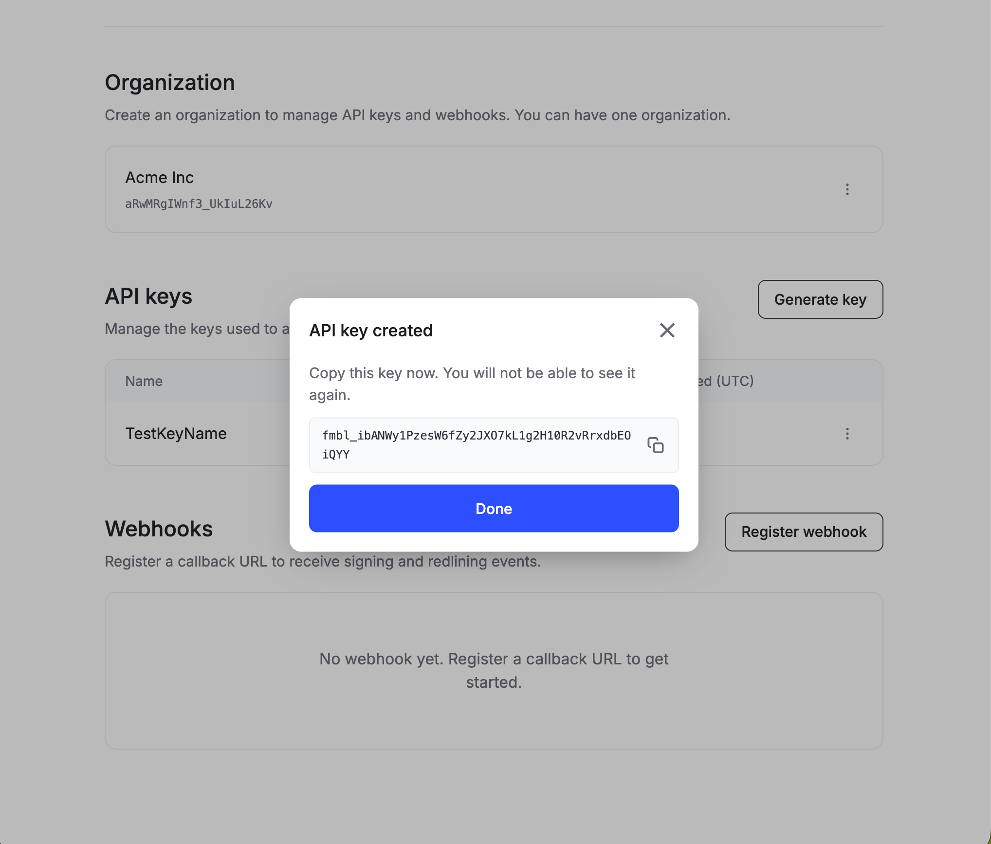 API key created modal showing a full fmbl_ key with a copy button