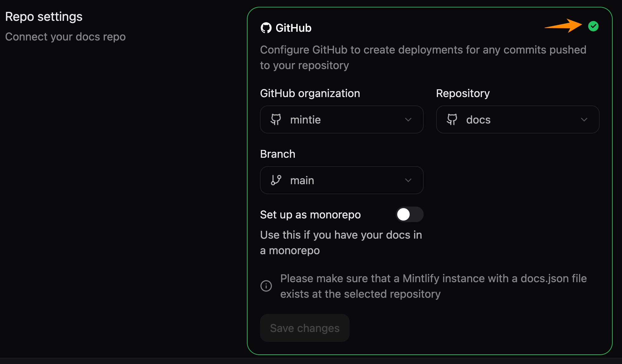 The Git Settings page in the Mintlify dashboard. An orange arrow points to the green check mark that revalidates the repository settings.