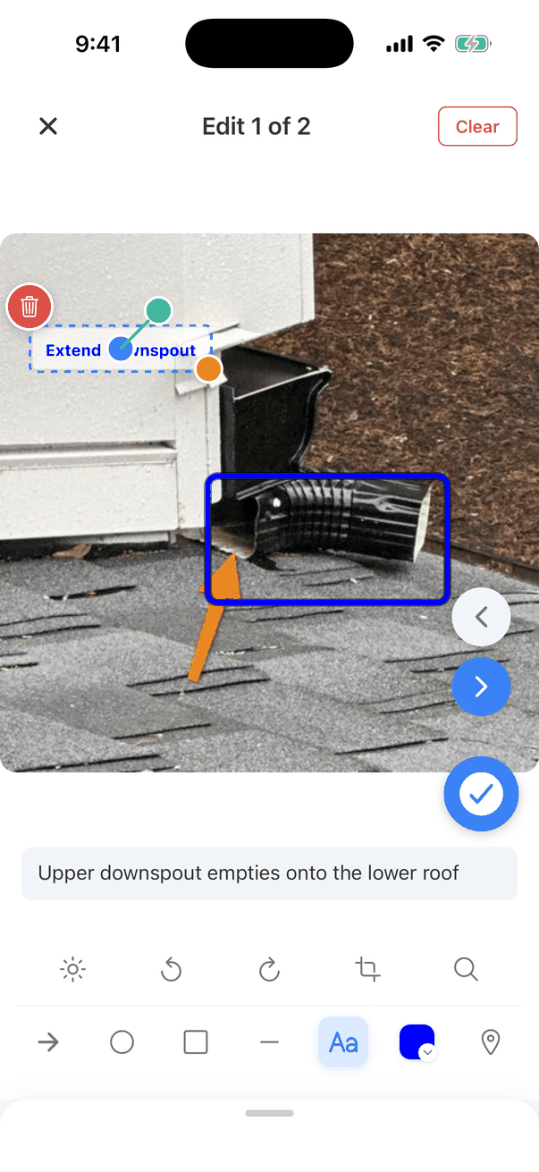 The photo with a blue box around the downspout and the selected text label Extend downspout, showing a red trash button, a green rotate handle, an orange resize handle and a blue move handle