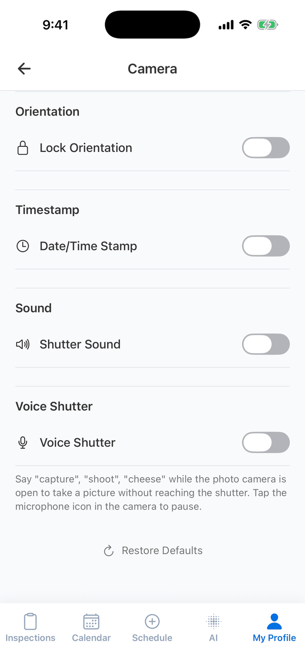 The lower part of Camera settings: Lock Orientation, Date/Time Stamp and Shutter Sound turned off, and Voice Shutter turned off, with the note Say capture, shoot, cheese while the photo camera is open to take a picture without reaching the shutter. Tap the microphone icon in the camera to pause. A Restore Defaults button