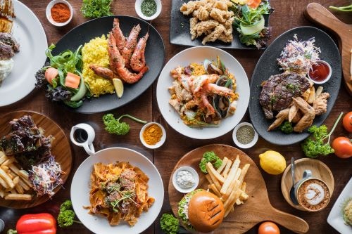 Photograph of a dinner table with several plates of food.
